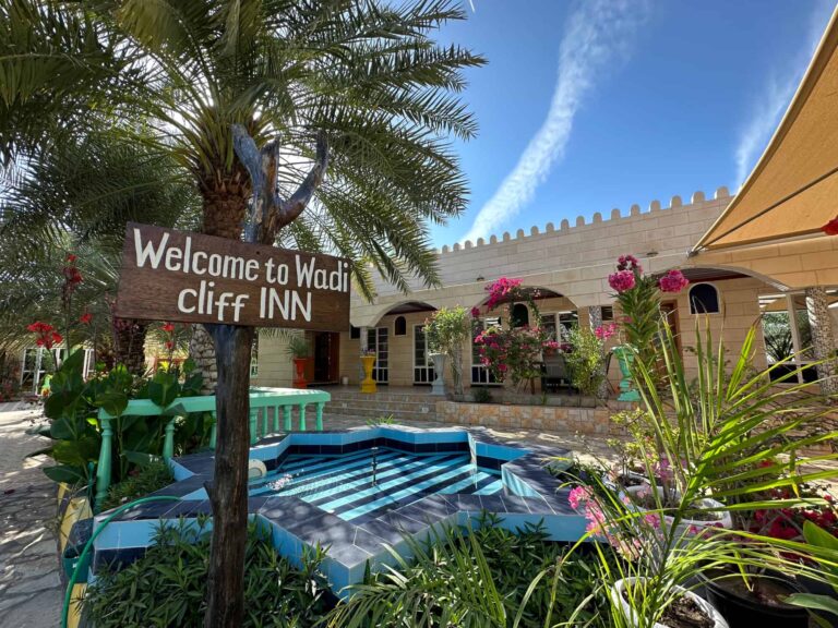 Welcome to Valley Cliff Inn sign in gardens outside villa