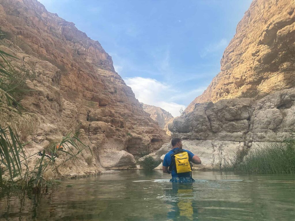 Mr Tin Box wades into the first turquoise pool in Wadi Shab.