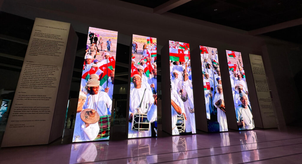 Five tall electronic display board show a scene of celebration