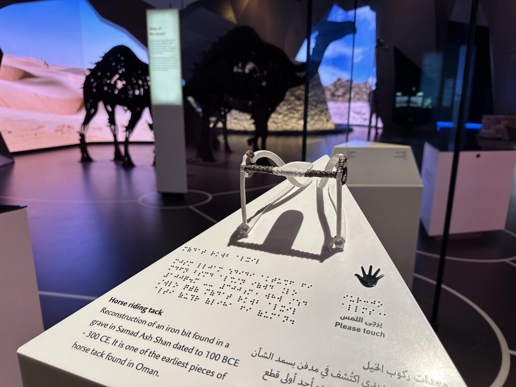 Accessible information board showing with information about horse tack alongside Arabic braille