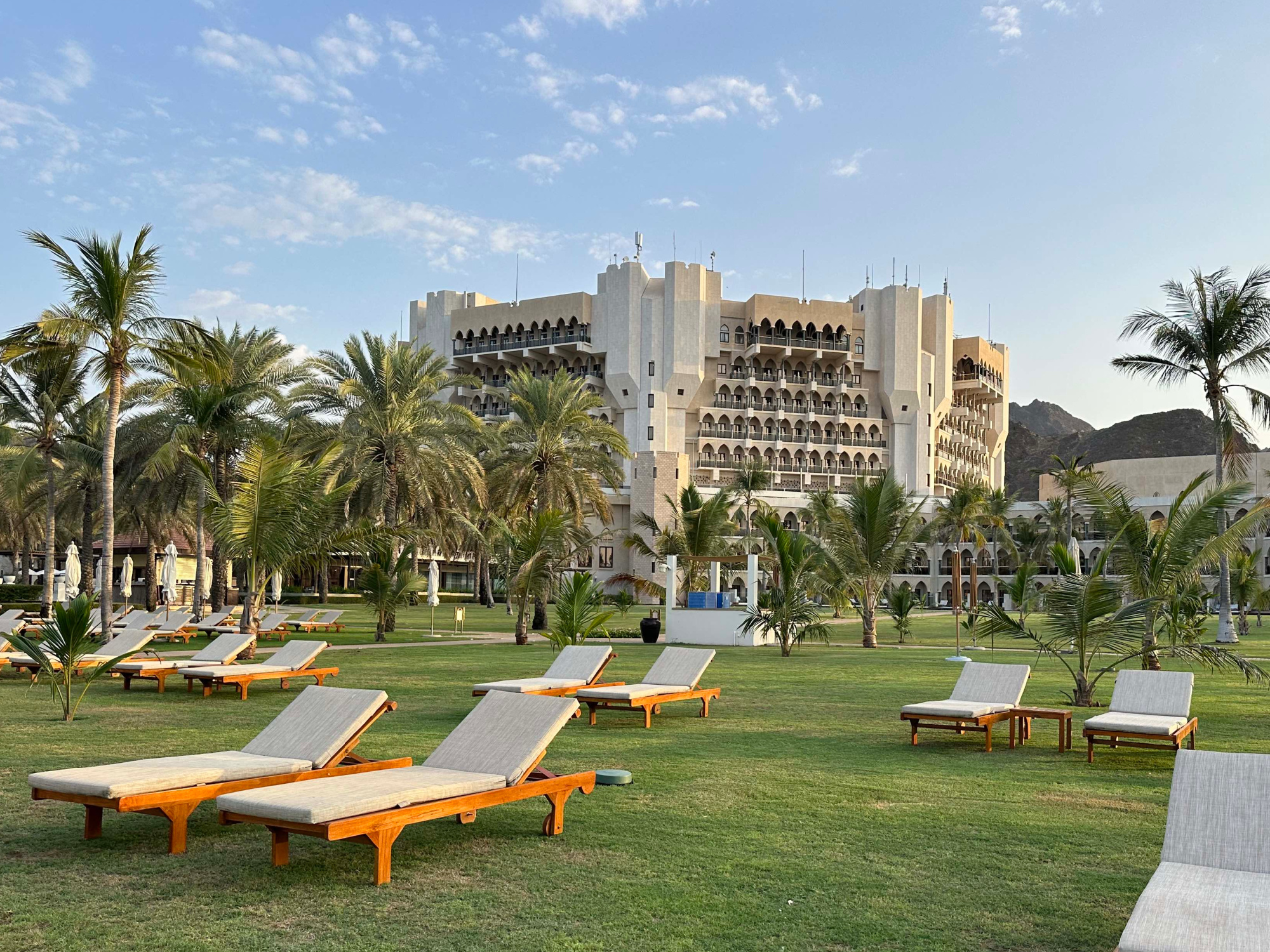 Sun beds on the lawn outside the Al Bustan Palace hotel in Muscat