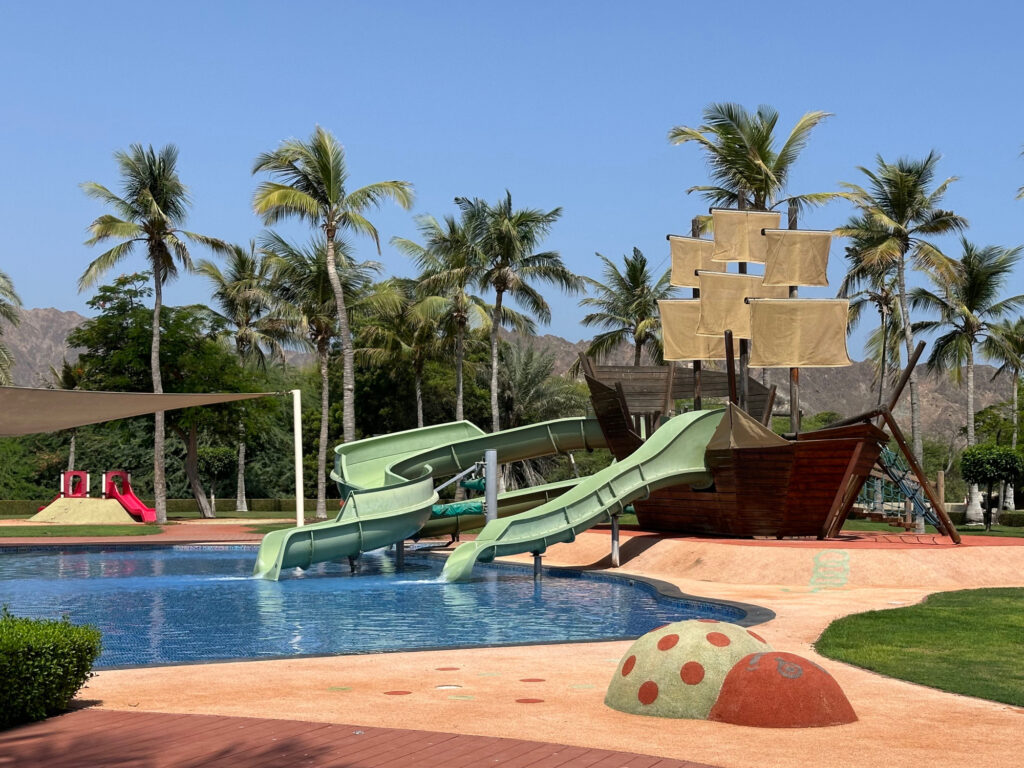 A pirate ship themes splash park with slides at the Al Bustan Palace family-friendly hotel in Oman