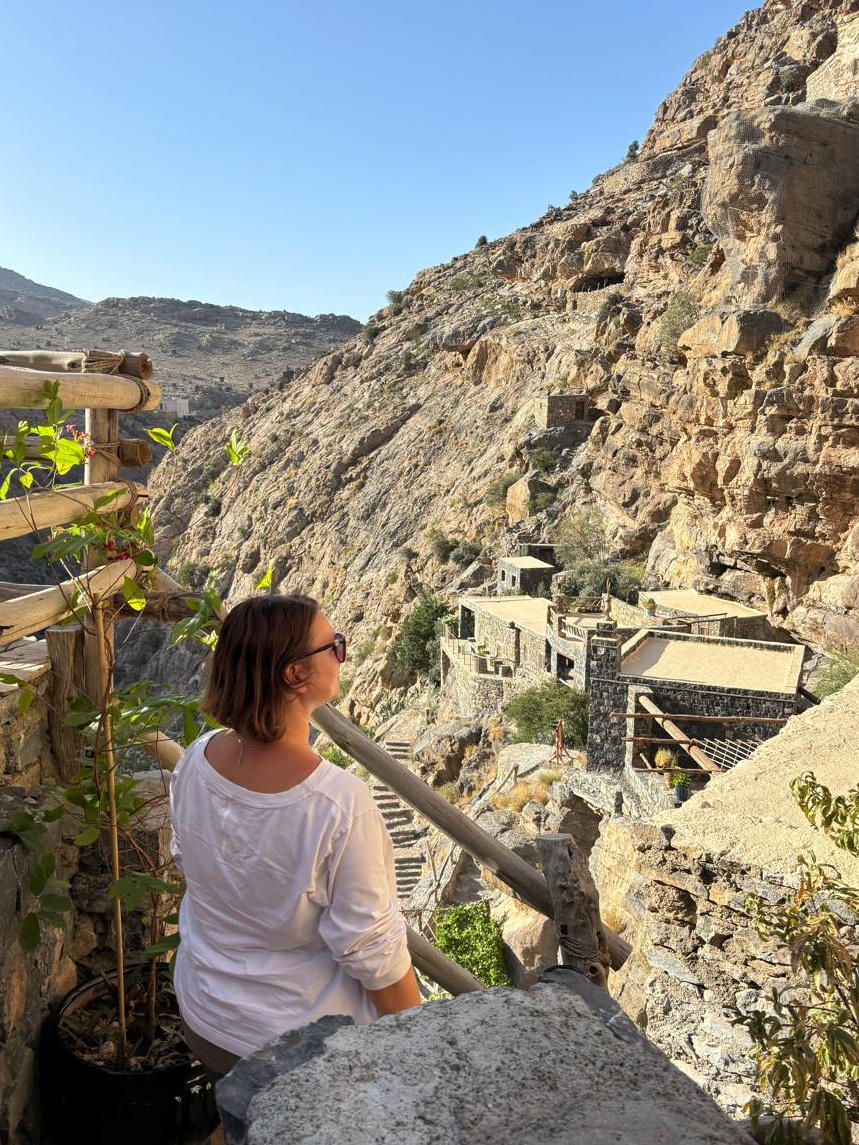 Claire soot looking out at Suwgra heritage inn on Jebel Akhdar