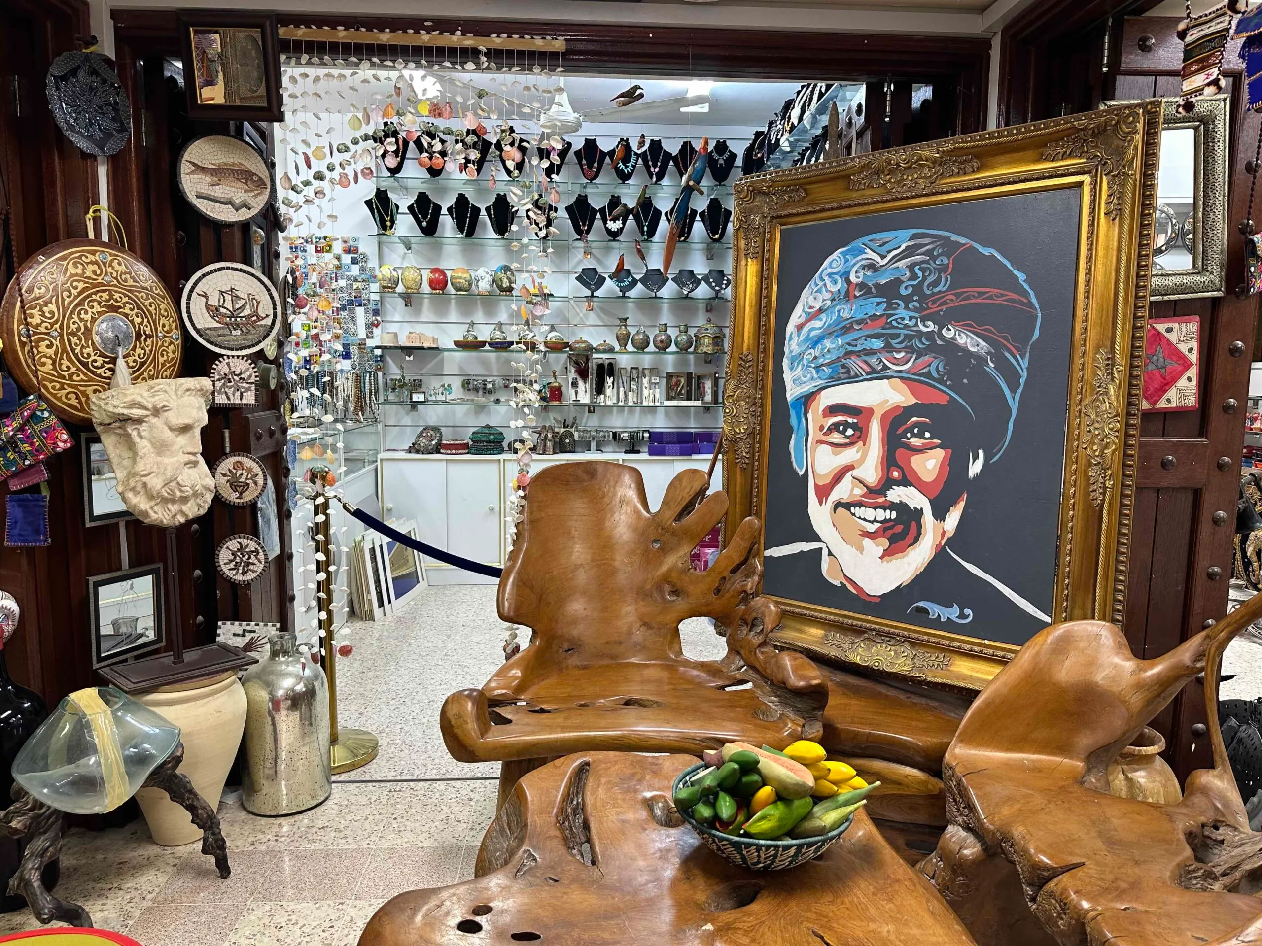 Portrait of Sultan Qaboos and antiques in the Souq at Nizwa