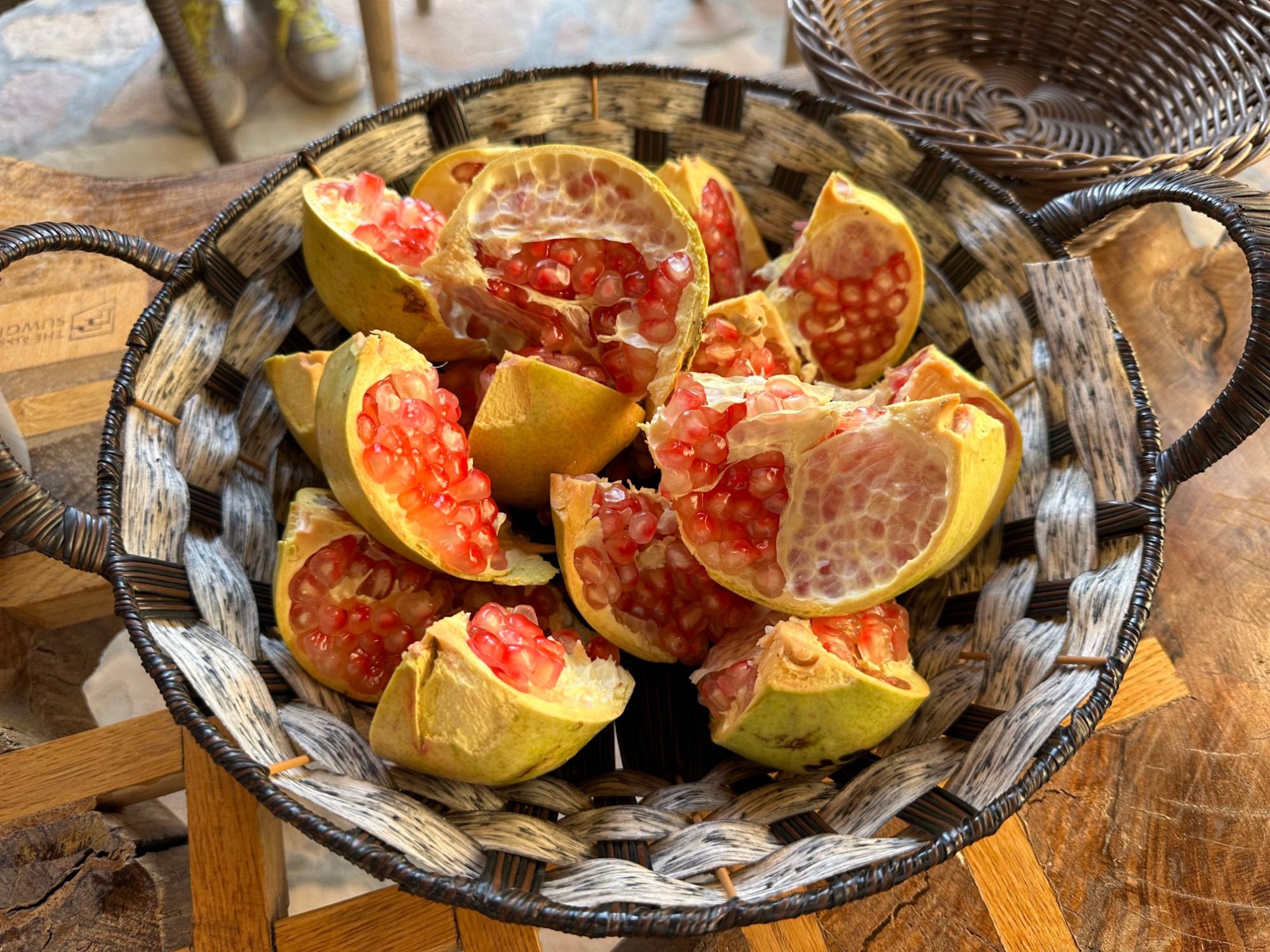 A woven bowl of freshly cut pomegranates