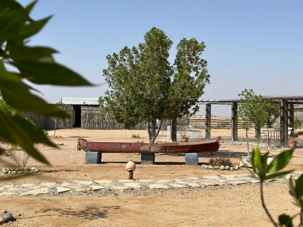 A rustic looking fishing boat in the grounds of SAM Ras Al Jinz Resort