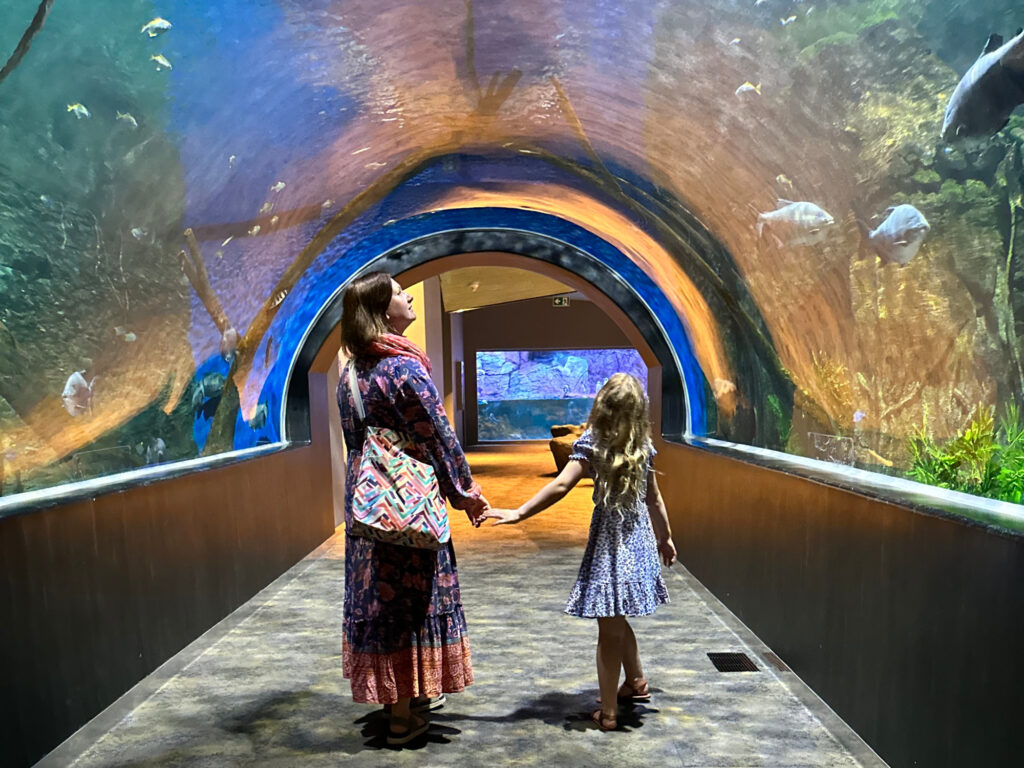 My daughter and I walking through the glass tunnel at Oman Aquarium