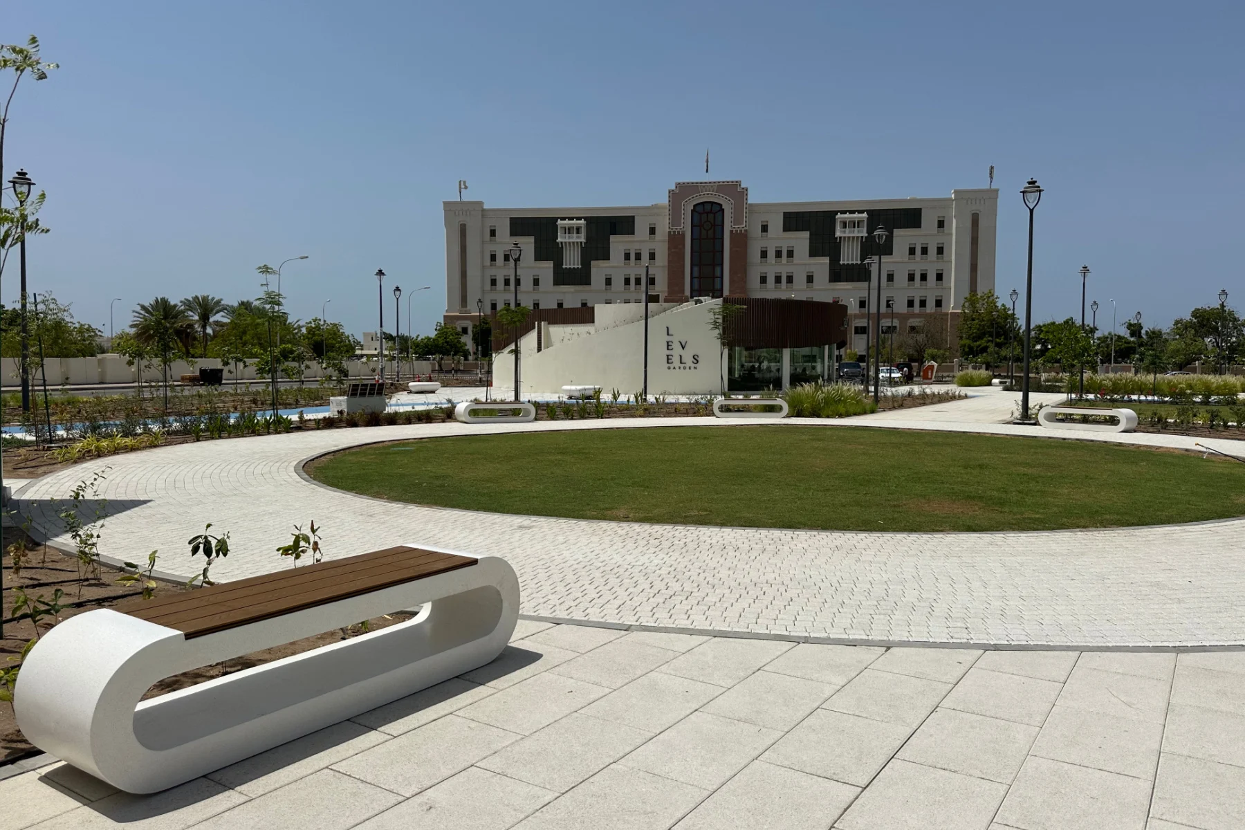 A view towards the Levels Gardens Cafe in Al Khuwair Square and a ministry building beyond