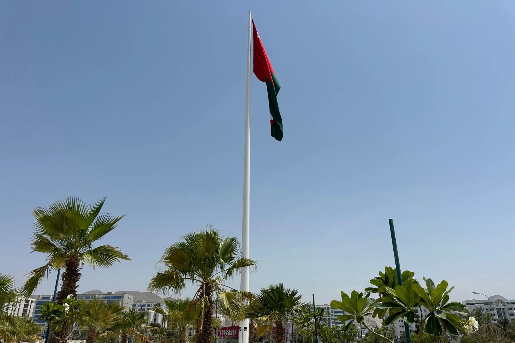 The Muscat flagpole flying an Omani flag above the Al Khuwair Square gardens