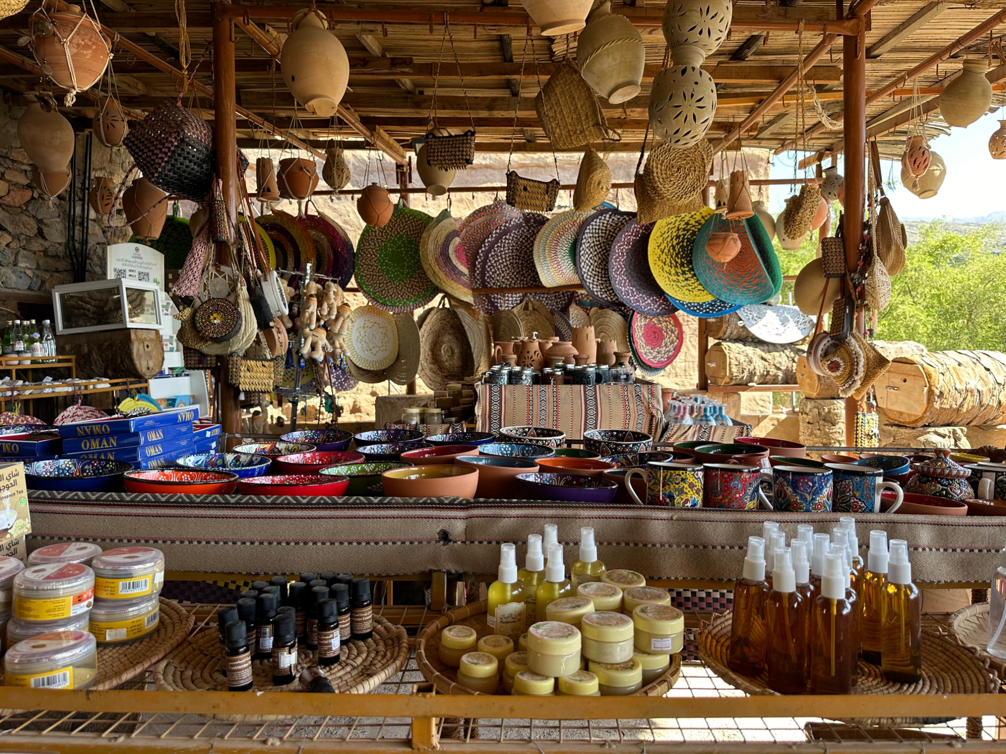 Woven mats, pottery jars of frankincense and honey in the shop at Misfat Al Abriyeen