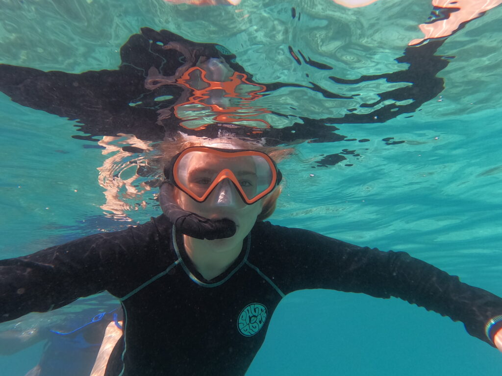 Our daughter wearing a snorkel and mask in the water at the Daymaniat Islands off Muscat