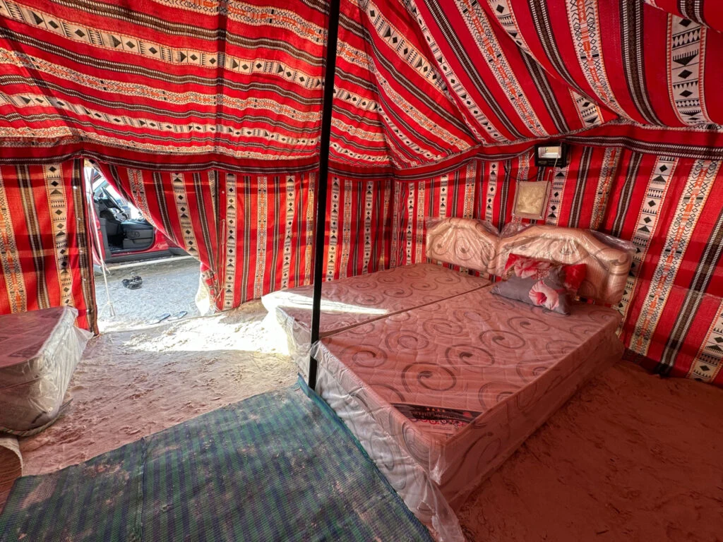 Twin beds inside a four person Bedouin-style tent