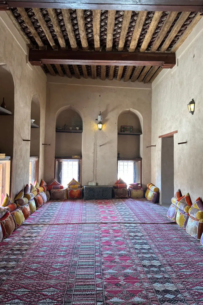 A carpeted room within the fort with cushions around the edge