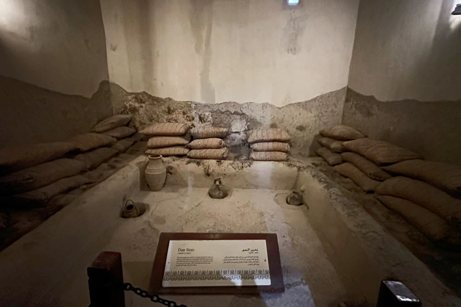 A very dark room where sacks of dates are stored