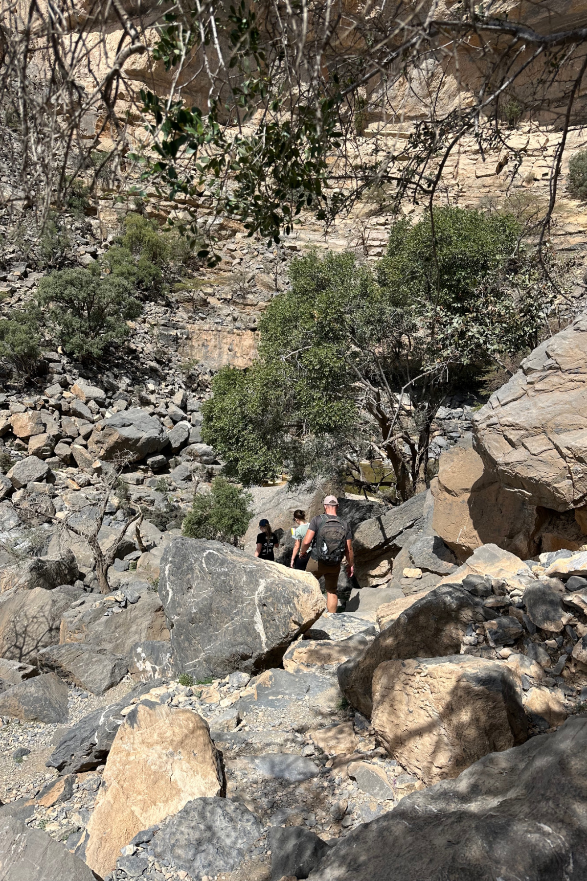 A faint path through the rocks before you reach the hidden pool at the abandoned village of As Sab