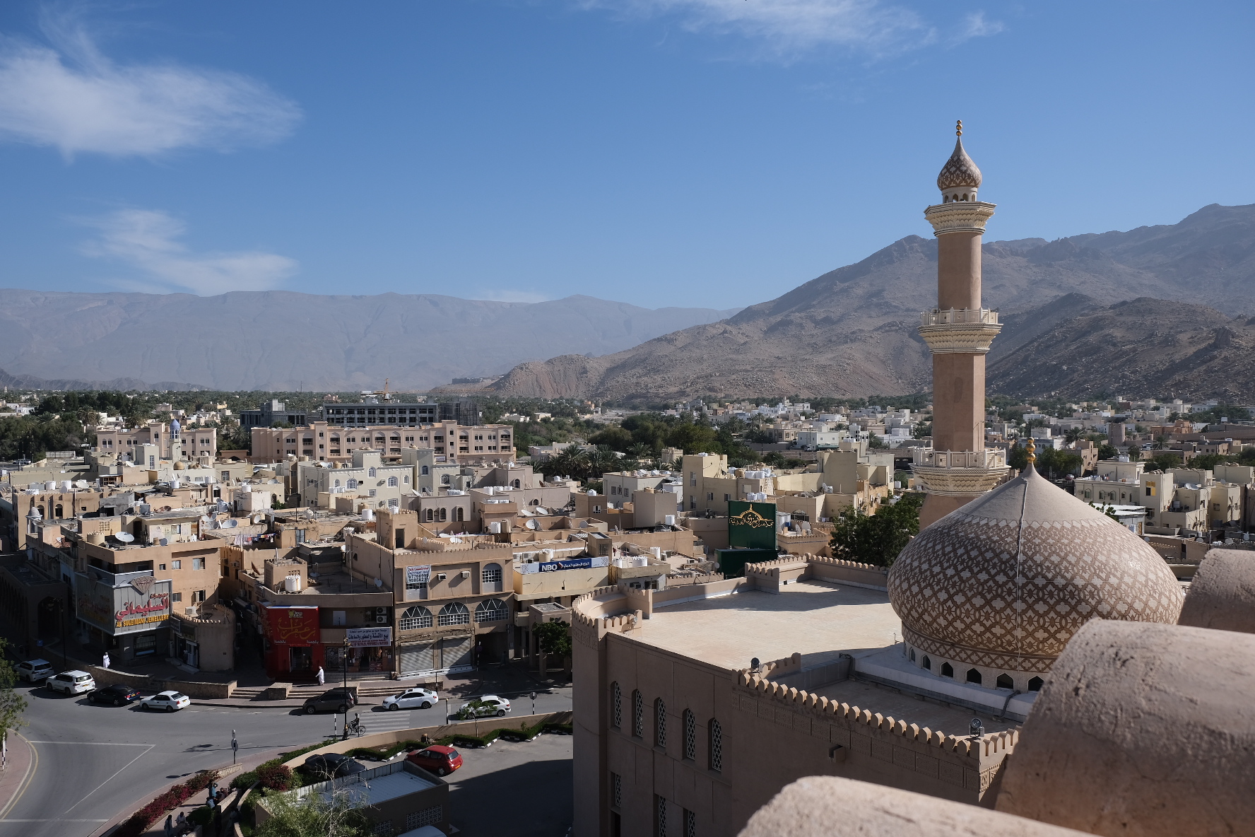 A view across the roof tops of Nizwa from the castle. The Hajar Mountains are in the background