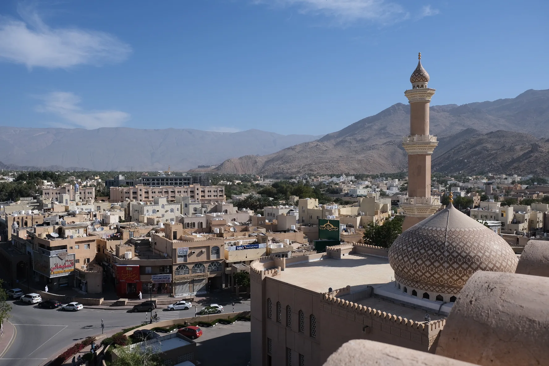A view across the roof tops of Nizwa from the castle. The Hajar Mountains are in the background