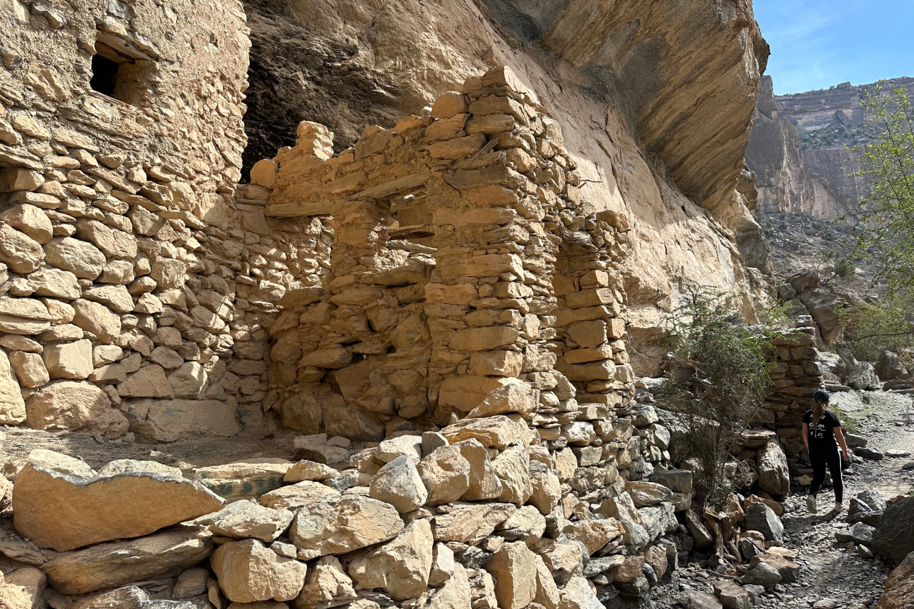 A crumbling stone house of As Sab Village built onto the cliff side