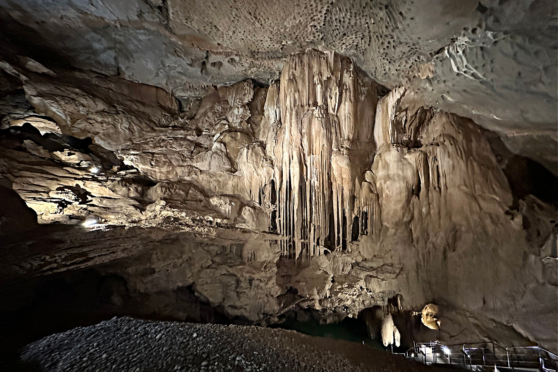 Huge stalactite columns fall down the inside of the cave