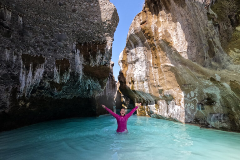 Our daughter jumping out of milky blue water in the canyon at Wadi Hoqain
