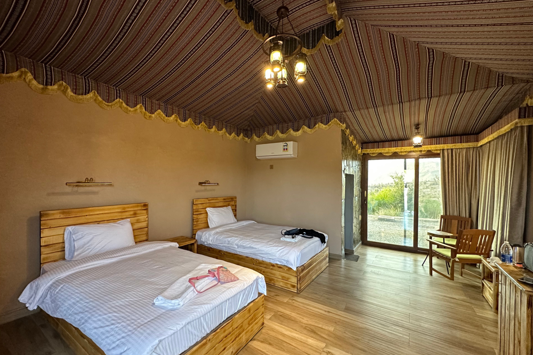 Twin beds in our room. The ceiling is hung with Bedouin style drapes