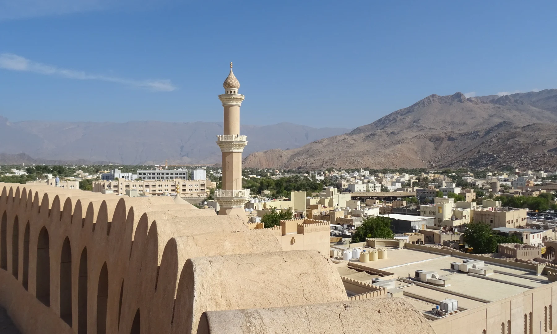 A view across the roof tops of Nizwa from the Fort. The Hajar Mountains are in the background