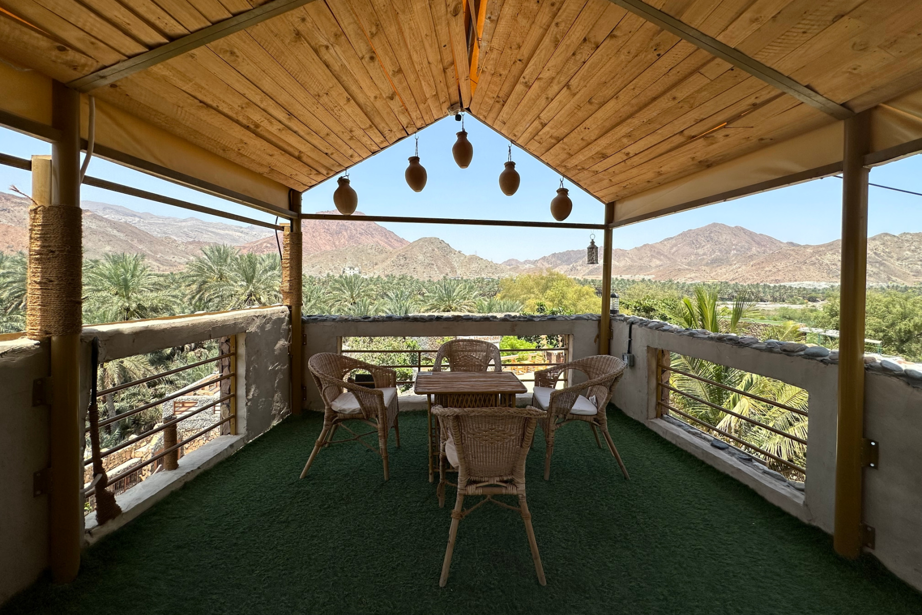 The terrace at Fanja Heritage House overlooking palms in the wadi valley below
