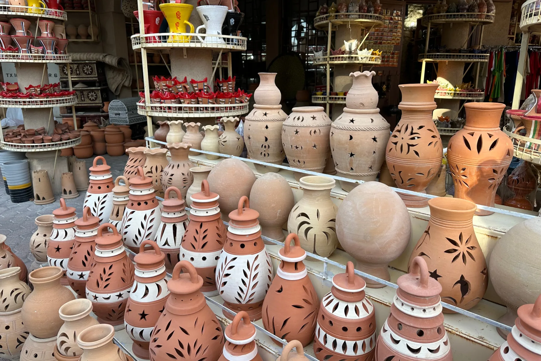 Patterned pottery displayed outside souq shops in Nizwa