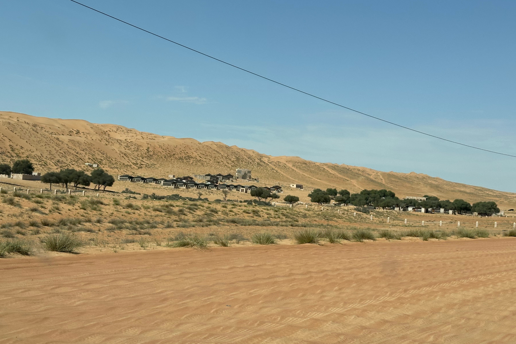 A view of Thousand Nights camp from the Bedouin Road as we drove past. There is a big dune behind the camp buildings