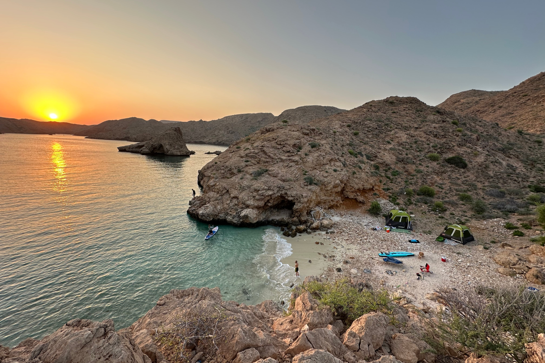 Sun rise over a small cove in Bander Khayran where we have pitched tents on the beach with friends. Behind our tents there are cliffs