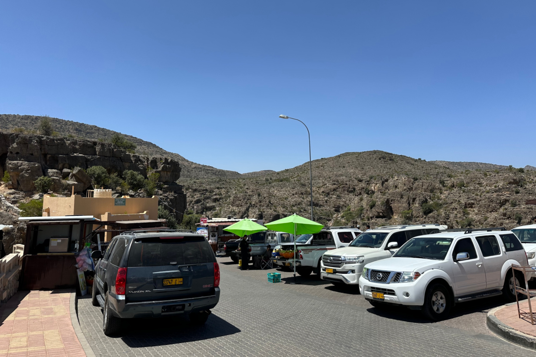 Cars lining the car park at the top of the valley about Bani Habib village on Jebel Akhdar