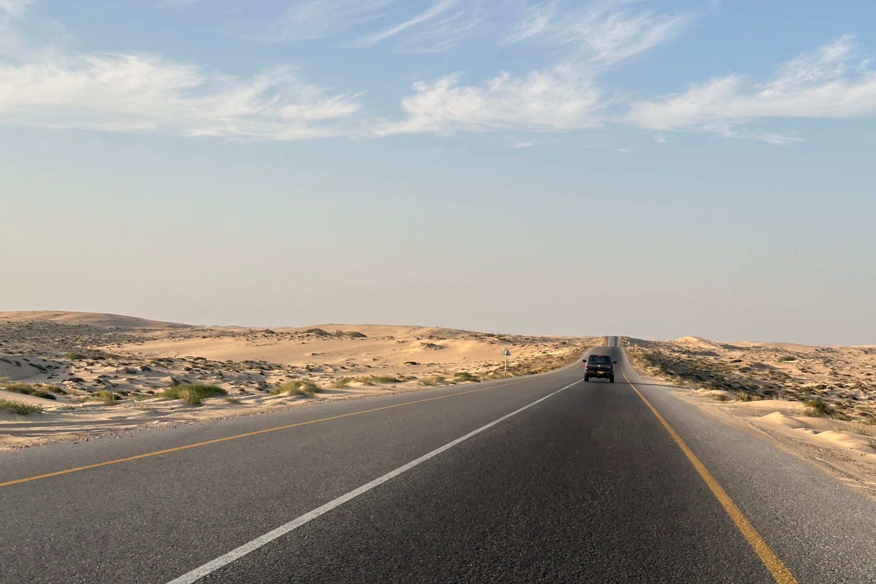 The coast road between Mahoot and Ghalat. It is two lanes of tarmac with sand on either side
