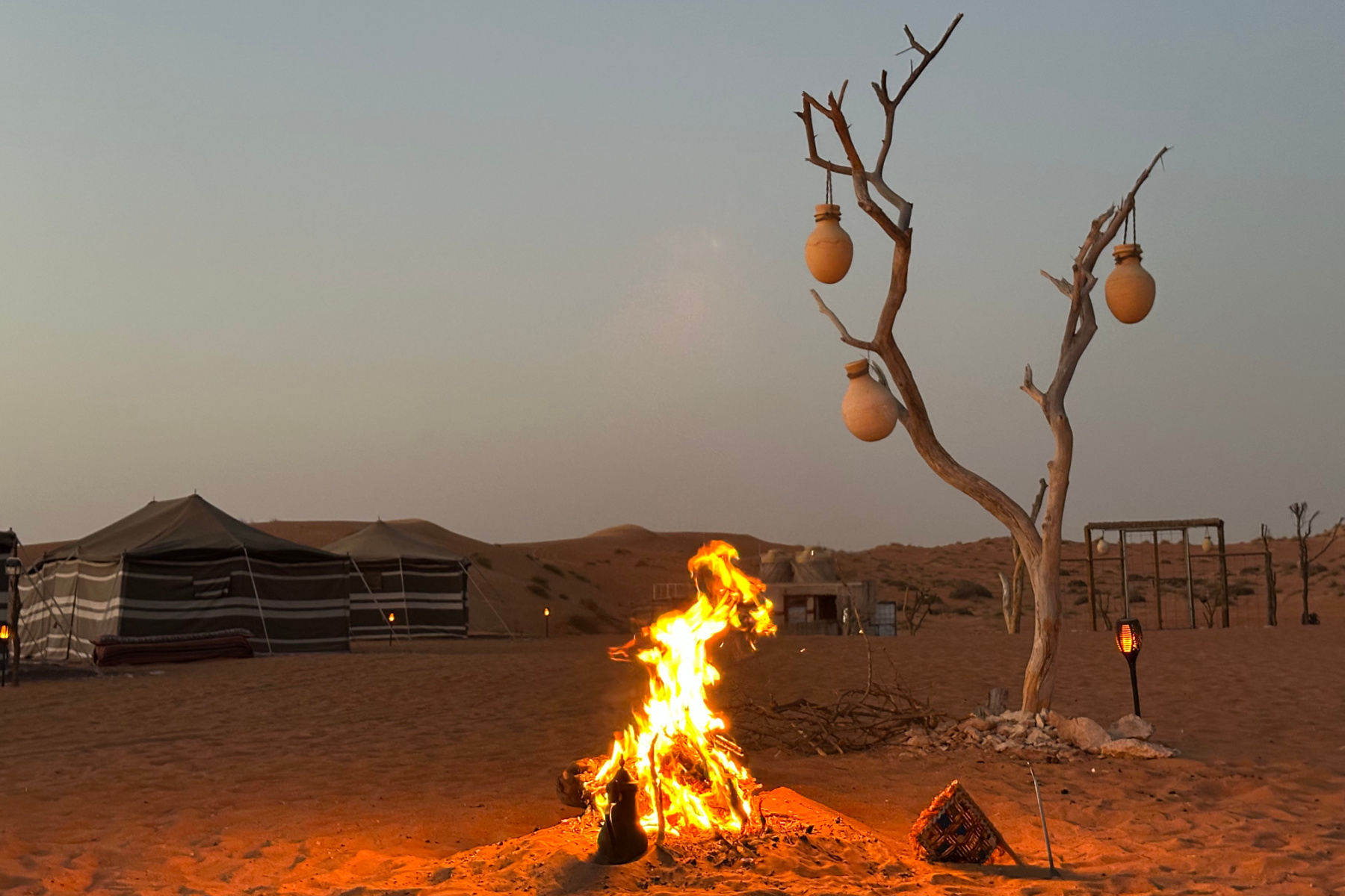 The camp fire rages in the twlight