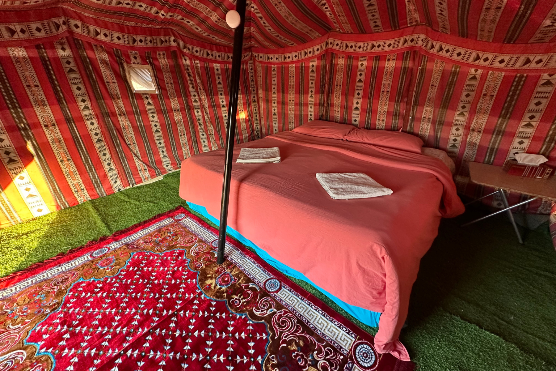 A double bed inside one of the Bedouin tents. The decor is Bedouin style an simple