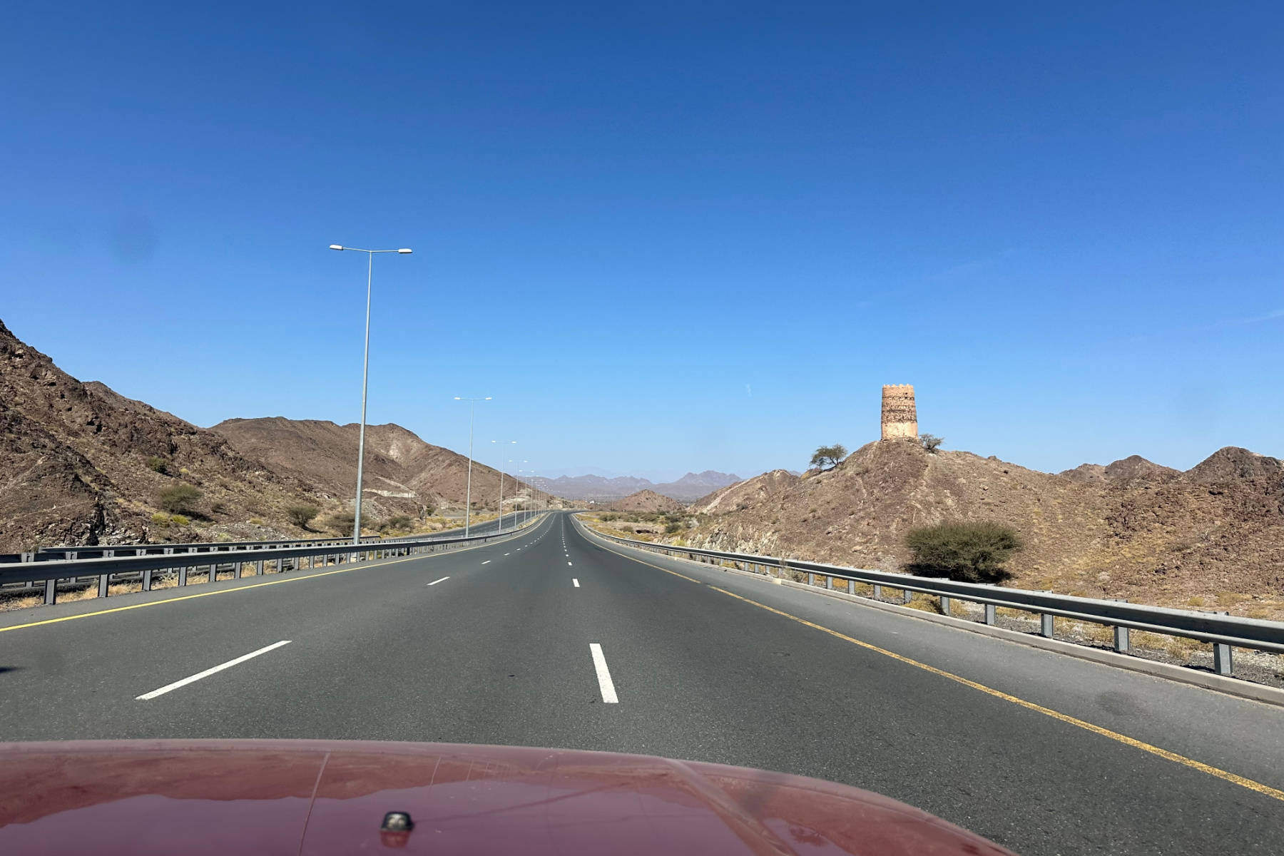 A three lane motorway with no cars. This is Route 23 on the way to Wahiba Sands