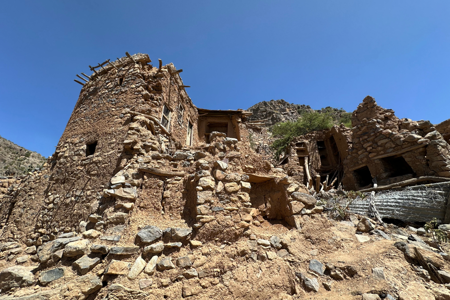A view of a crumbling mud brick building in the mountain village of Wadi Bani Habib