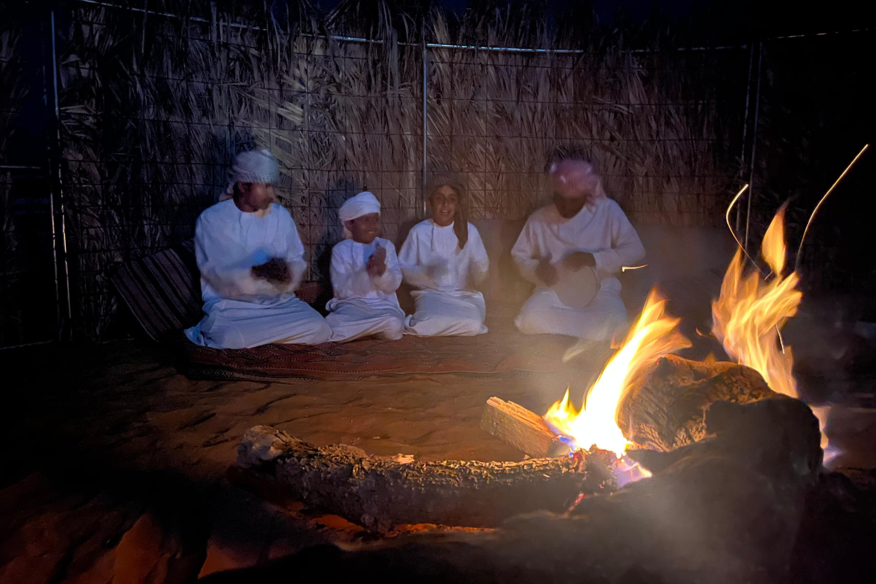 Bader and his family sing around the camp fire