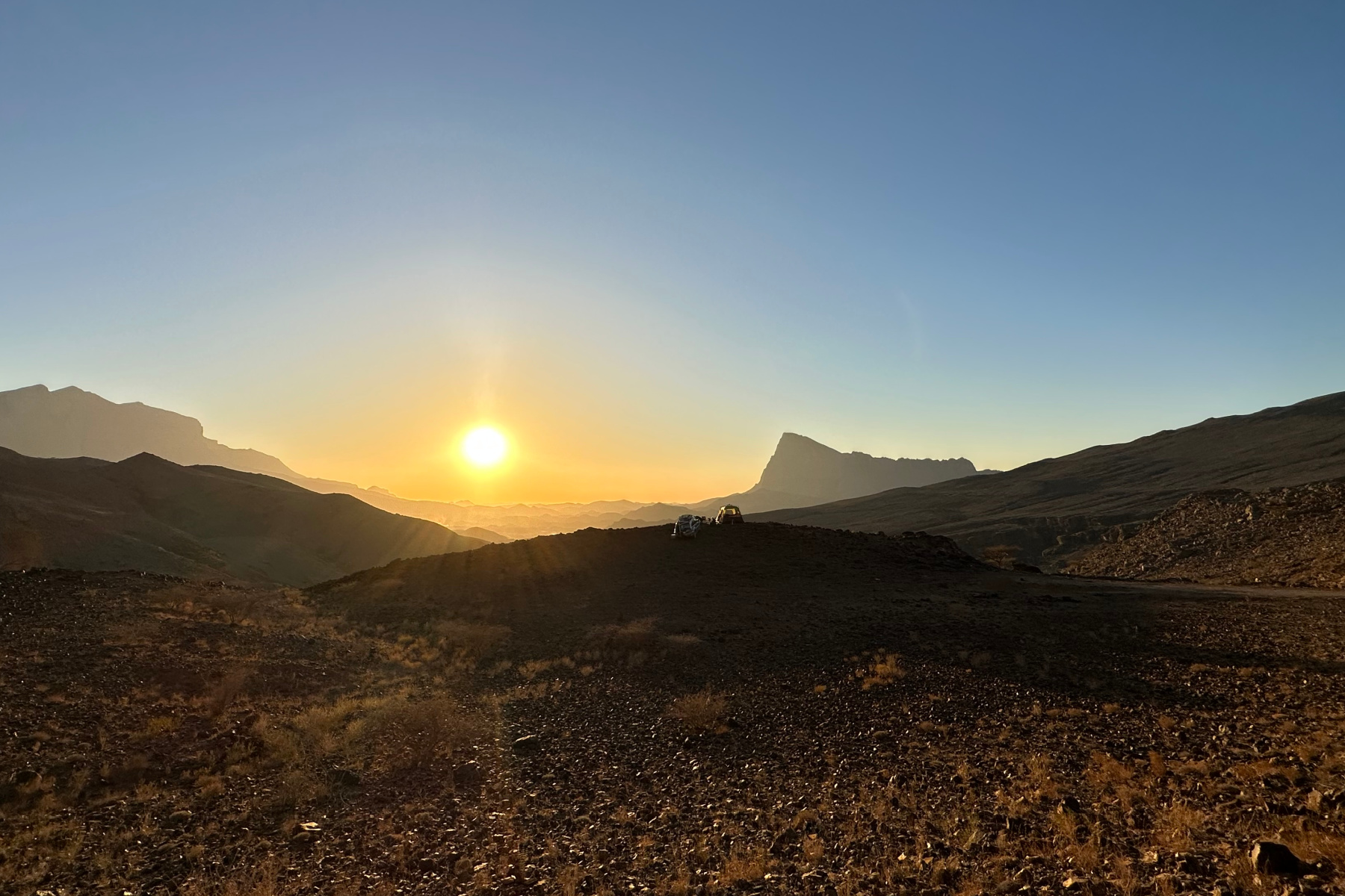 A view of Jebel Misht at sunset. on the horizon you can just see our car and tent