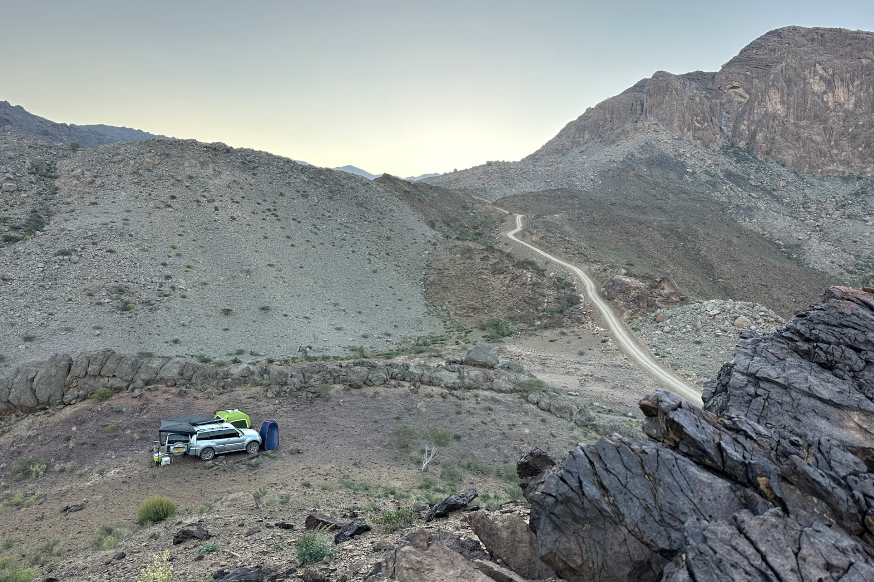 A view down onto our tent and car parked in a valley near Wadi Damm