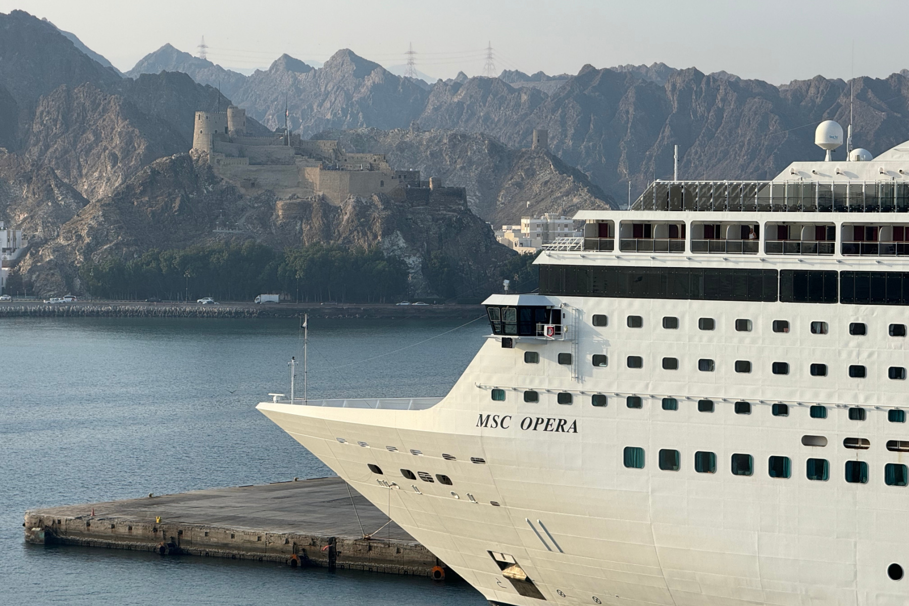 An MSC cruise ship at the cruise terminal in Sultan Qaboos Port in Muttrah Muscat. The Hajar Mountains are on the horizon
