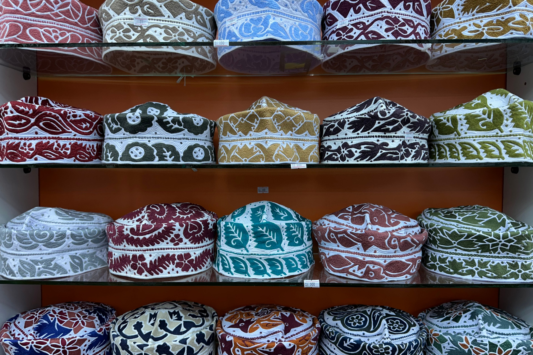 Rows of colourful Kummah caps - the traiditonal head dress of Omani men