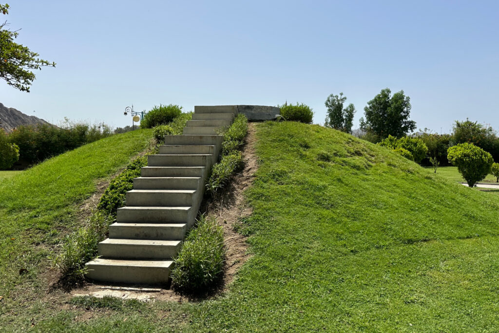 Concrete steps up a grassy mound in Riyam Park