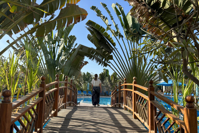 My eldest daughter walking across a bridge towards the hotel's pool