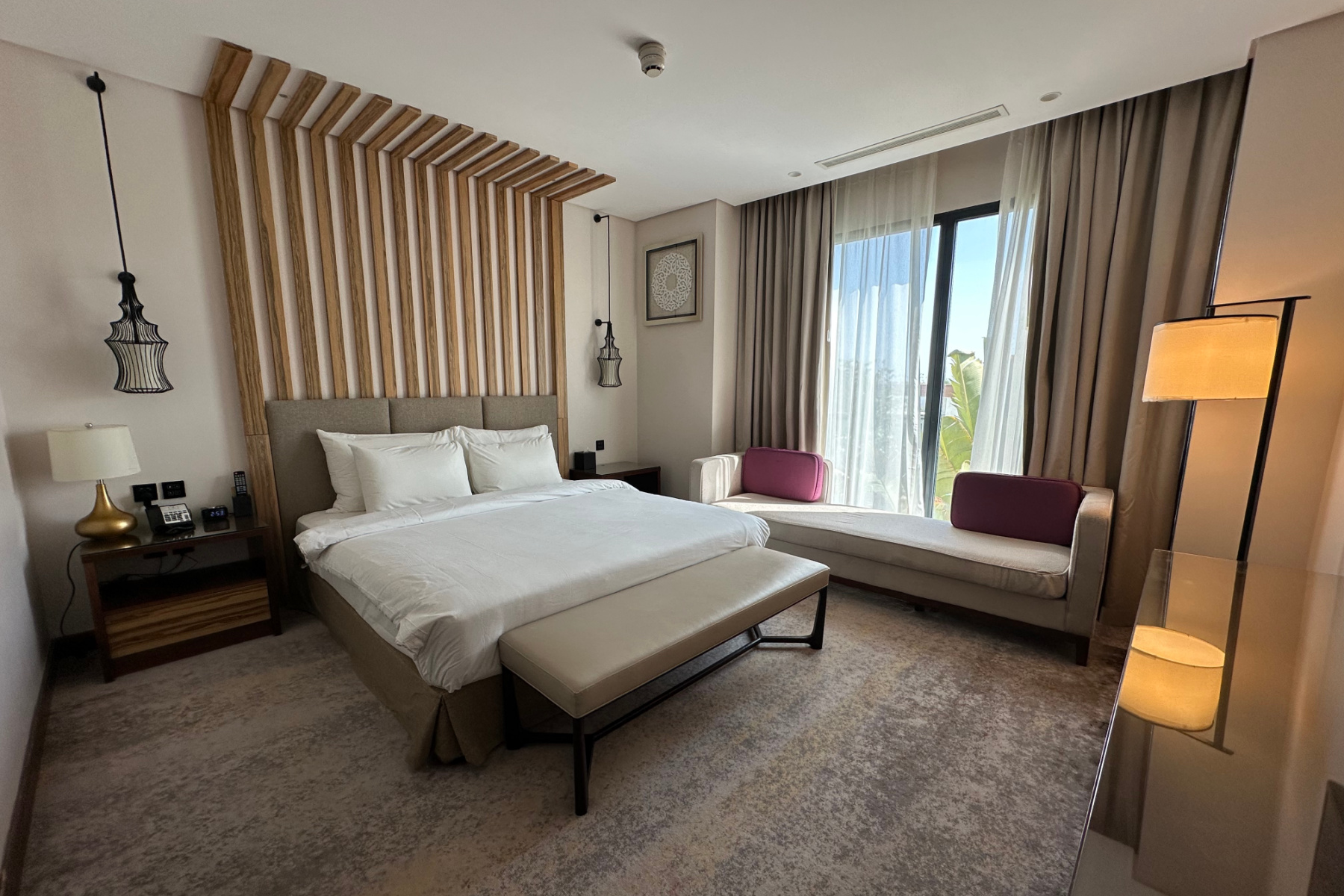 Our double bedroom with a super king bed and light wood furnishings
