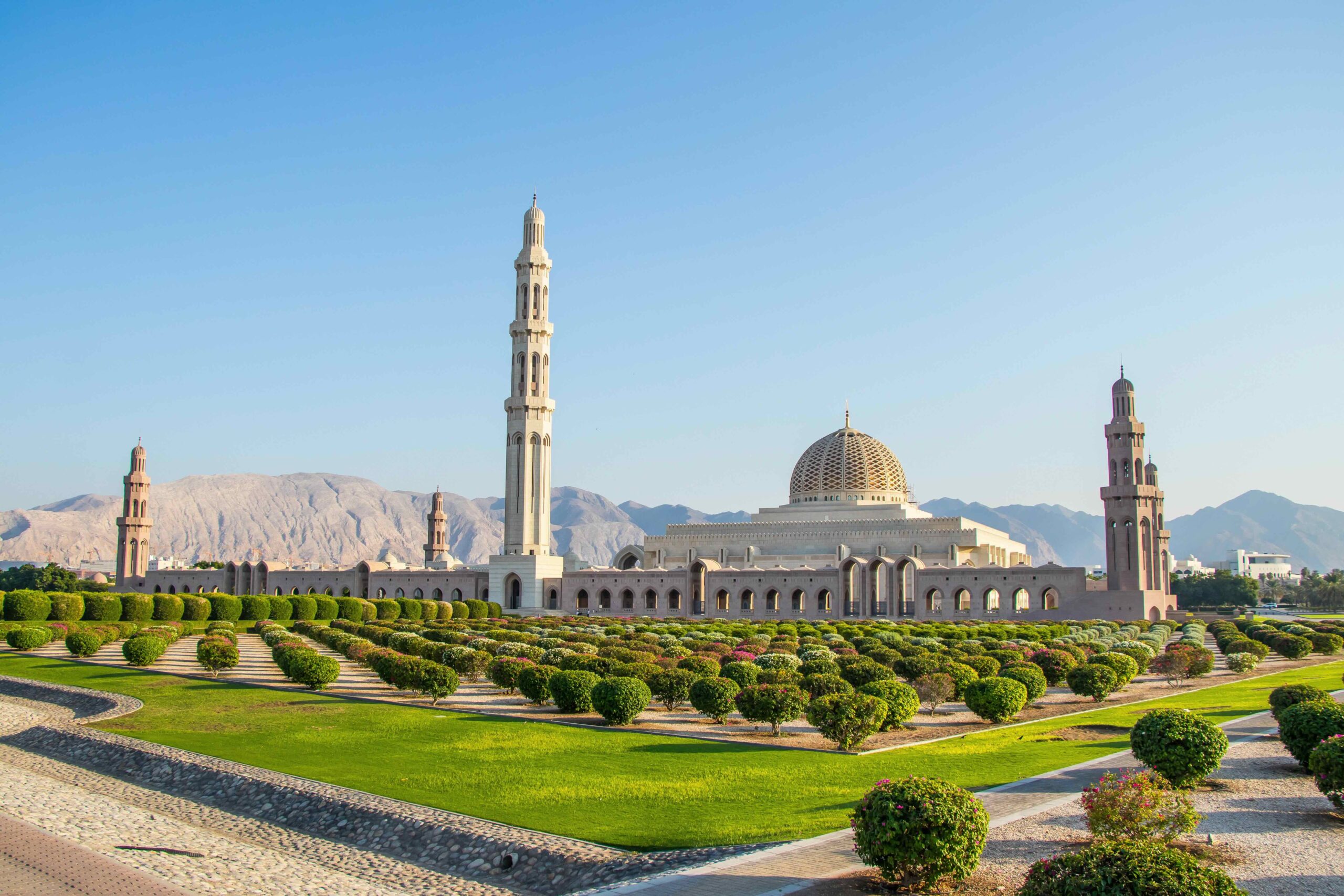 A view of the Grand Mosque and gardens backed by the Hajar Mountiains