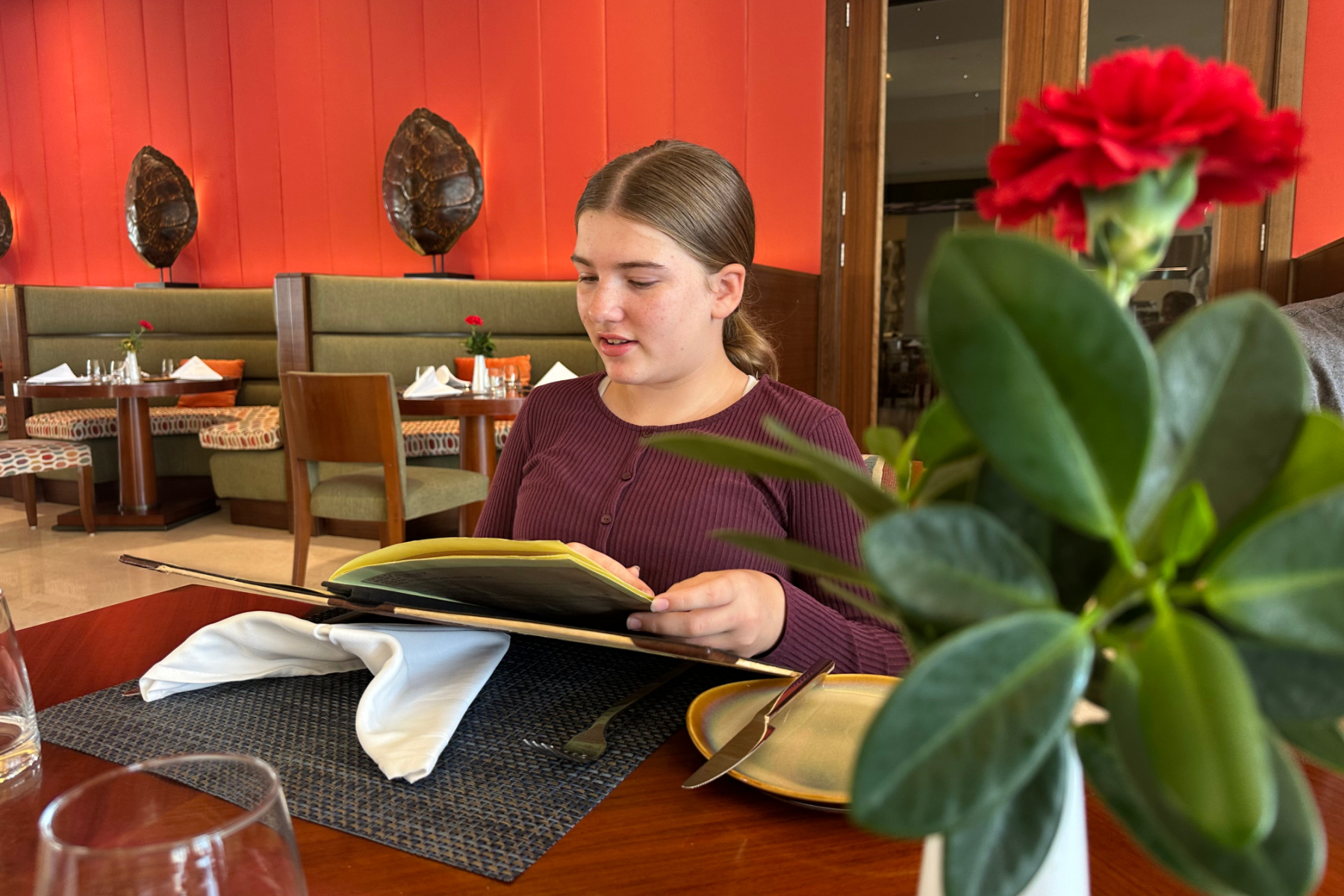 My daughter looking at the menu in the Souq Restaurant of the Crowne Plaza