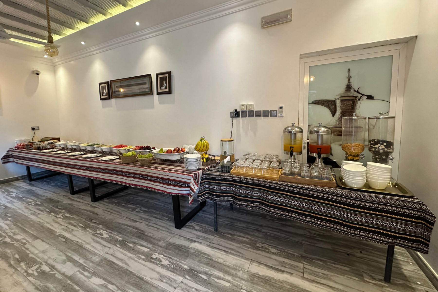 Breakfast buffet room at Wadi Al Arbeieen. There are canteens laid out with fruit, cereals, pastries and cooked Arabic breakfast