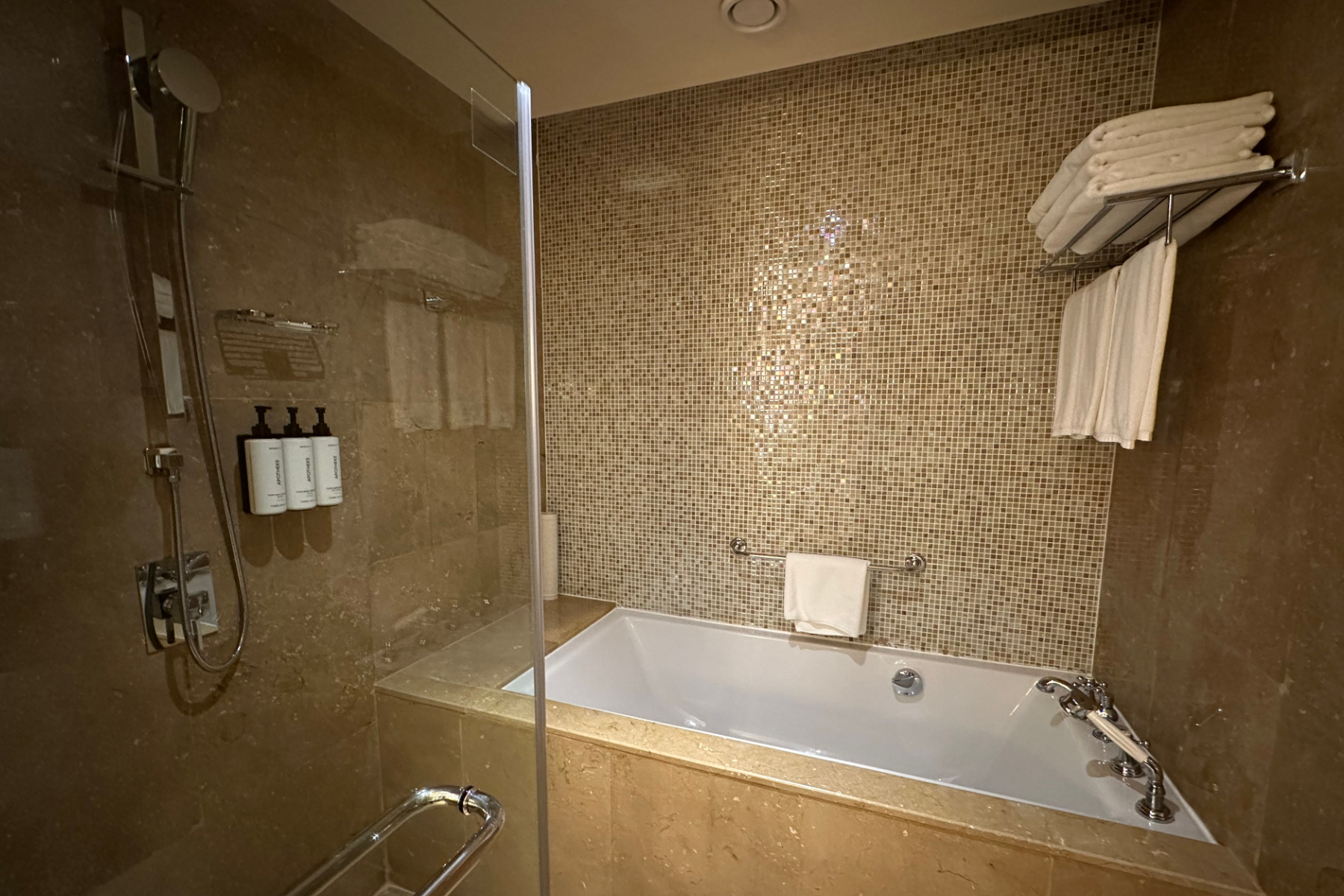 The deep bath tub and shower area in the ensuite bathroom of our hotel room at the Crowne Plaza Duqm