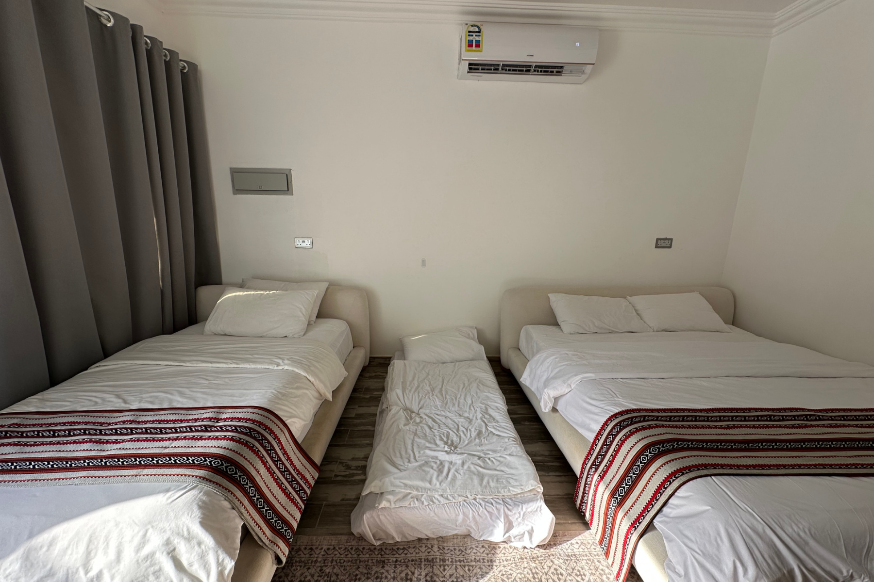 A double bed, mattress on the floor and a single bed in our room at Wadi Al Arbeieen Resort
