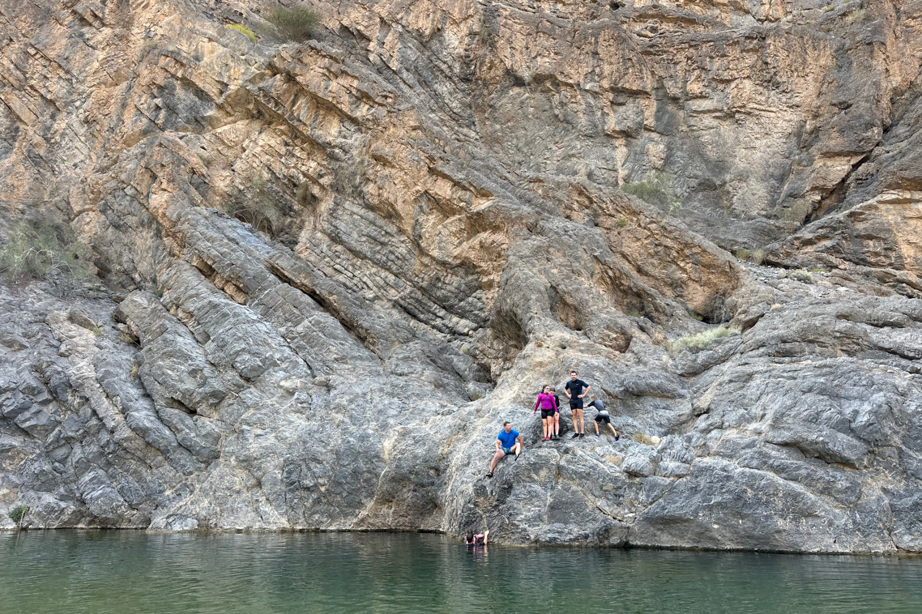 Our children jumping off rocks into the wadi pool below